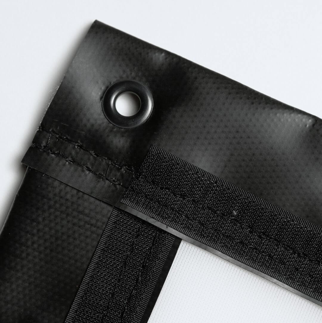 Premium golf simulator impact screen with reinforced corner grommet for secure mounting